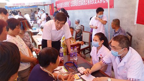 图为鲁勇一行看望北京按摩医院在王寺镇开展义诊活动的医护工作者和村民