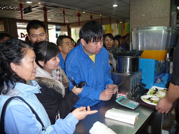 图为学员指导智残人学习点餐